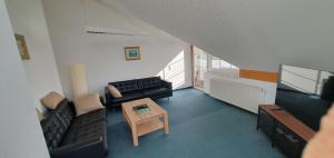 a living room with a couch and a table at Alpenblick in Leutkirch im Allgäu