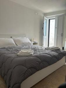 a bedroom with a bed with two towels on it at B&B Suite "Caniglia" in Mesagne