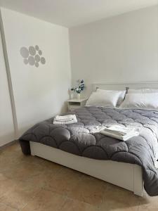 a bedroom with a large bed with two towels on it at B&B Suite "Caniglia" in Mesagne