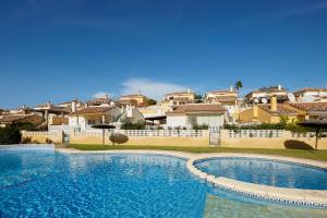 a large swimming pool in front of some houses at Villa con vistas al mar in Alicante
