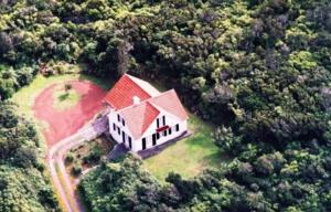 an aerial view of a large house in the woods at Casa do Areal in São Roque do Pico