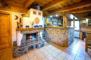 a living room with a stone fireplace in a house at Drevenica pod Sitieňom 1 in Lazisko