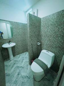 a bathroom with a toilet and a sink at At Thara Aonang in Ao Nang Beach
