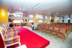 a room with rows of chairs and a red carpet at Rusty Rock Beach Resort & Spa in Mwanza +56 photos