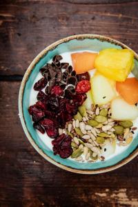 a bowl of fruit and nuts on a wooden table at Long John's Pub & Hotel in Amersfoort