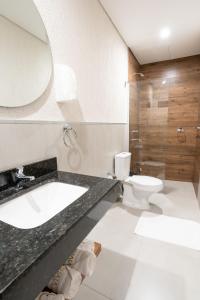a bathroom with a sink and a toilet at VIVARIUM APART HOTEL in Asuncion