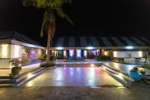 a night view of a pool at a resort at Rusty Rock Beach Resort & Spa in Mwanza