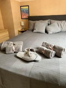 a bed with a pair of sandals and towels on it at Studio lumineux avec balcon à proximité de la mer in Nice