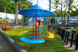 a playground with a slide in the grass at Rusty Rock Beach Resort & Spa in Mwanza