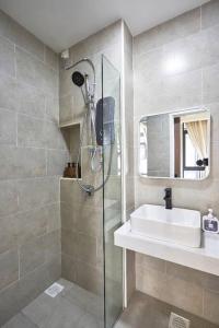uma casa de banho com um chuveiro, um lavatório e um espelho. em Zen Leisure House @mount austin tebrau Ikea em Johor Bahru
