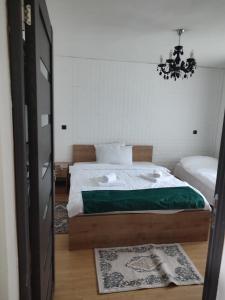 a bedroom with a bed and a chandelier at Cabana Good Vibes in Cluj-Napoca