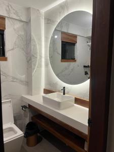 a bathroom with a sink and a mirror at Cabaña Los Sauces en Buena Vista Santa Cruz in Buena Vista