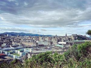 a view of a large city with buildings at Garden Flat in Edinburgh