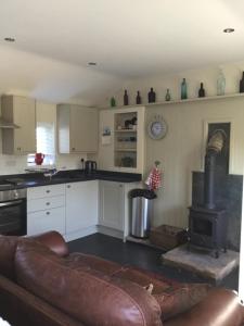 a kitchen with a couch and a stove at The Stable in Stourbridge