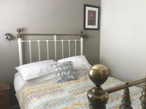 a bedroom with a bed with a metal frame at The Stable in Stourbridge