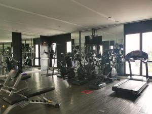 a gym with a bunch of treadmills and machines at G63 Pool access room Espana Condo Resort Pattaya in Jomtien Beach