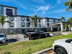 a building with cars parked in front of it at Sleep Inn & Suites Lakeland I-4 in Lakeland