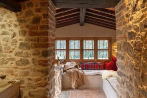 a room with a bench in a stone wall at La Tuscia - Tenuta Di Toscana, Boutique Villa in Gaiole in Chianti +41 photos