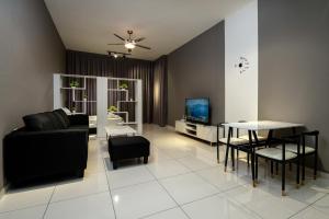 a living room with a couch and a table at Penang KTHOME Beacon Executives suite in George Town +18 photos