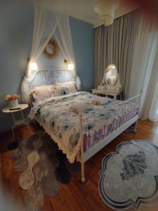 a bedroom with a large bed with a canopy at Irene's cozy apartment in Volos