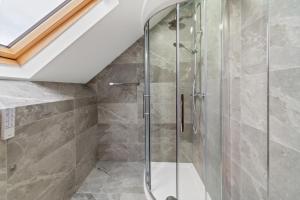a bathroom with a shower with a glass door at High Standard City Center Leicester in Leicester