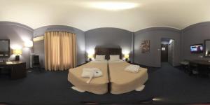um quarto de hotel com uma cama com toalhas em Galini Hotel em Itea