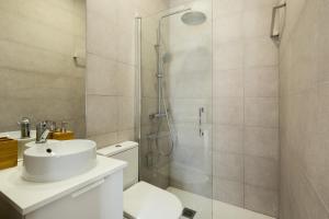 y baño con ducha, aseo y lavamanos. en Veoapartment Elcano 14 en Sevilla