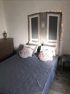 a bedroom with a blue bed with two windows at Hyper centre Sweet Cosy Bellifontaine 4 personnes in Fontainebleau