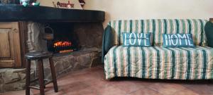 a couch in a living room with a fireplace at Spritz's Home in Castel di Sangro