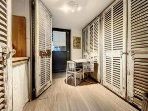 a room with wooden shutters and a table and chairs at Petit Nid in Strasbourg