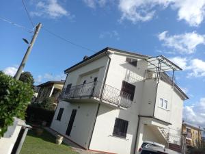 a white building with two balconies on it at Ca' LUCIANO in Castelnuovo Magra