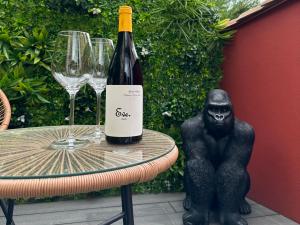a bottle of wine sitting on a table with wine glasses at Love Room Cholet Le Double L in Cholet