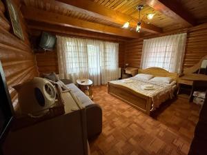 a bedroom with a bed and a tv in it at Guest House Sofia in Bukovel +107 photos