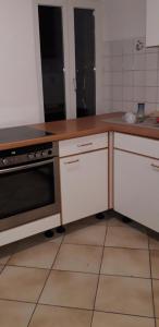 a kitchen with a stove and a counter top at CityHome am Markt in Saarbrücken