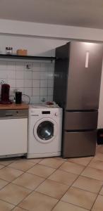 eine Küche mit einem Kühlschrank und einer Waschmaschine in der Unterkunft CityHome am Markt in Saarbrücken
