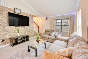 a living room with a couch and a tv at Charming High Point Home with Yard 4 Mi to HPU! in High Point