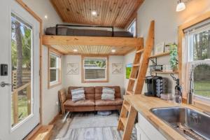 a tiny house with a couch in a kitchen at Summer Tiny House in West Palm Beach