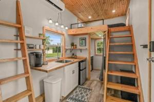 a tiny house with a kitchen and a loft at Tiny House hosted by Joe in West Palm Beach