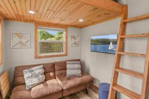 a living room with a couch and a ladder at Summer Tiny House in West Palm Beach