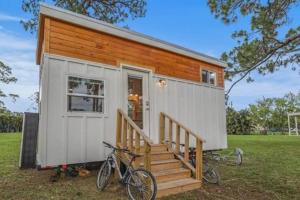 a tiny house with two bikes parked outside of it at Summer Tiny House in West Palm Beach