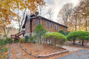 a wooden house with a staircase in front of it at Riverfront Blue Ridge Cabin with Private Hot Tub in Mill Spring