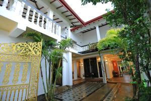 a courtyard of a house with a yellow gate at D Plus Resort Negombo in Negombo