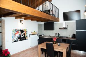 a kitchen and dining room with a wooden table at B & B CA’ D’ OLINA in Pavullo nel Frignano