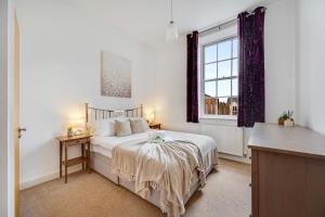 Schlafzimmer mit einem Bett und einem Fenster in der Unterkunft Pass the Keys Luxury 2 Apt in West Didsbury in Manchester