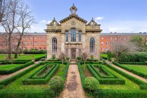 a large building with a garden in front of it at Pass the Keys Luxury 2 Apt in West Didsbury in Manchester