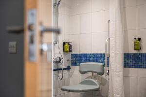 a bathroom with a shower with a toilet in it at Holiday Inn Express Ramsgate – Minster by IHG in Minster