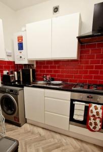 a kitchen with a sink and a stove top oven at Lovely Studio- Aldgate East Stn in London