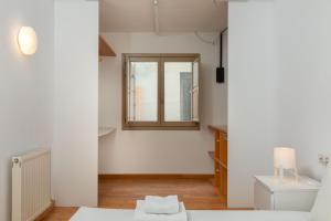 a white room with a window and a toilet at Flateli Cort Reial 7 in Girona