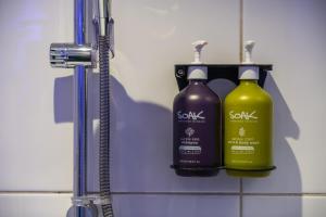 two bottles of soap on a shelf in a bathroom at Holiday Inn Express Ramsgate – Minster by IHG in Minster