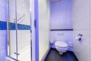a bathroom with a toilet and a shower at Holiday Inn Express Ramsgate – Minster by IHG in Minster